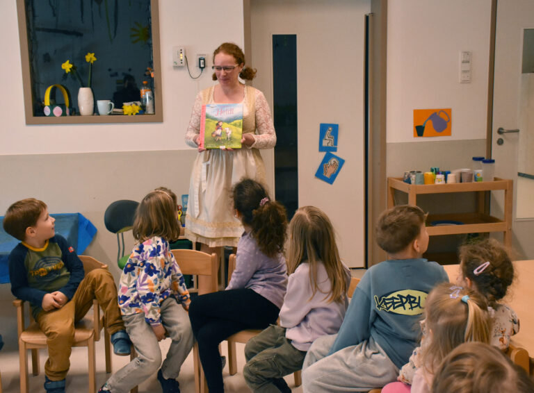 im Vordergrund eine Kindergruppe und dahinter Heidi