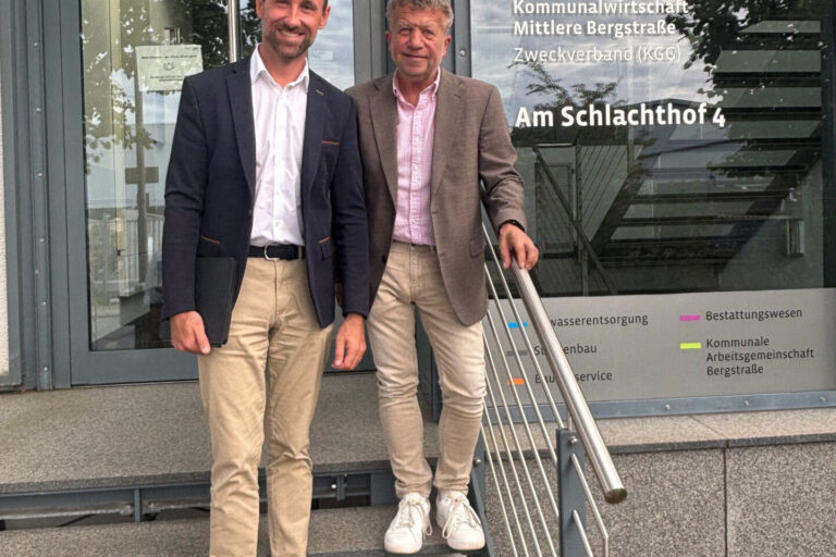 zwei Männern stehen auf einer Treppe vor einem Gebäude